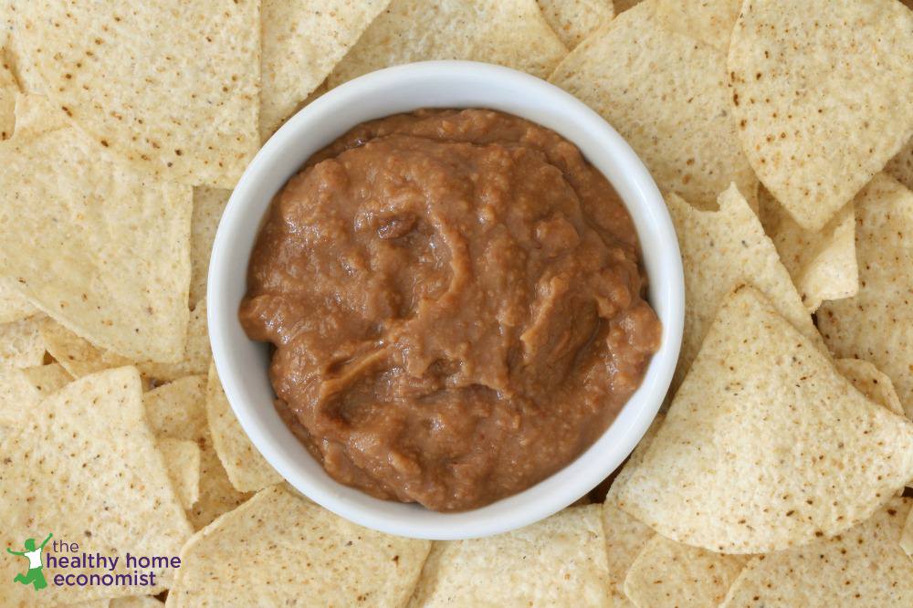 mexican refried beans in a bowl with chips