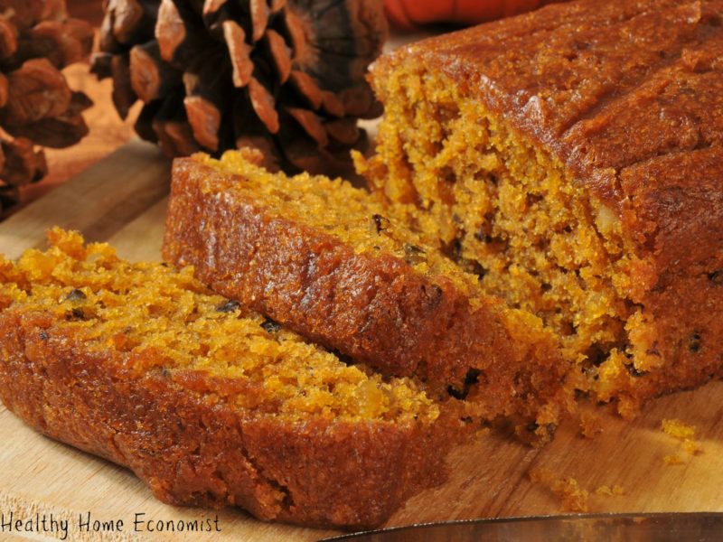 homemade pumpkin bread sliced on a wooden cutting board