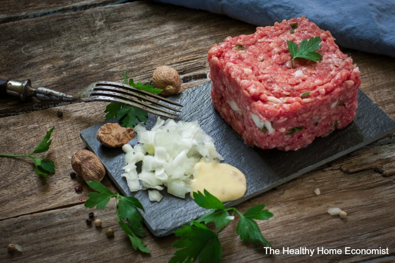 steak tartare on a cutting board with sauce