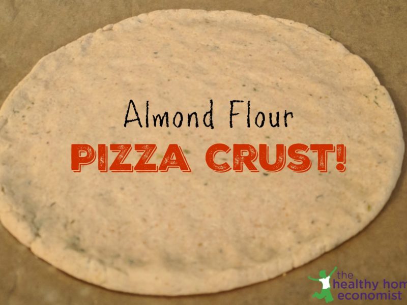 almond flour pizza crust dough rolled out on a cutting board