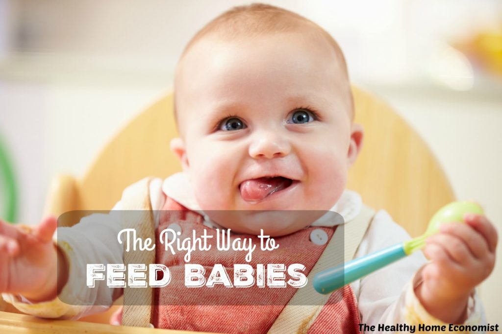 baby getting fed in a high chair