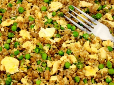 egg fried rice with peas on a plate with fork