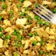 egg fried rice with peas on a plate with fork