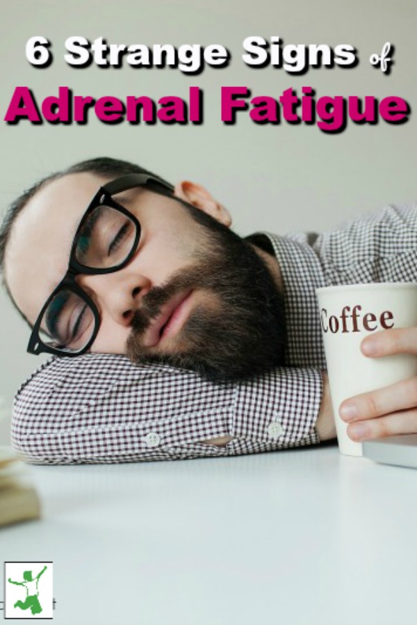 man with adrenal fatigue sleeps at his desk with a cup of coffee