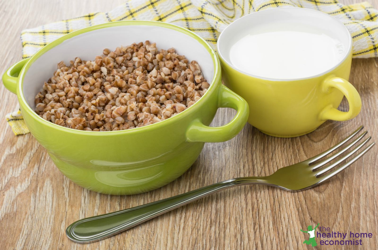 buckwheat cereal in a green bowl with cream on a table