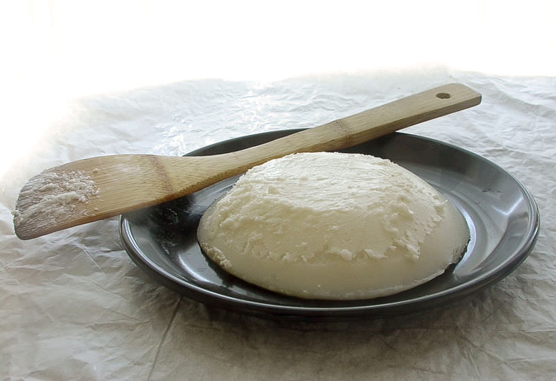 rendered lard on a plate with a wooden spatula