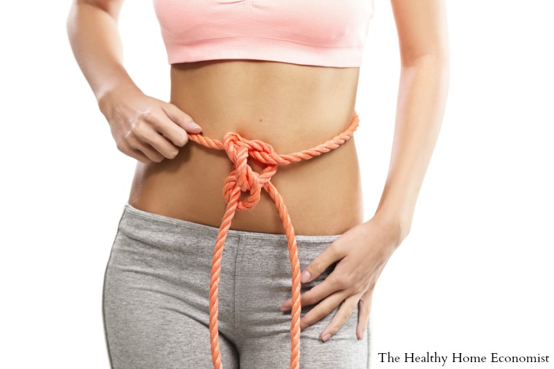 stomach pain and bloating resolved in young woman with slim waist