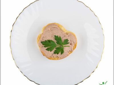 chicken liver and bacon pate spread on toast with parsley sprig