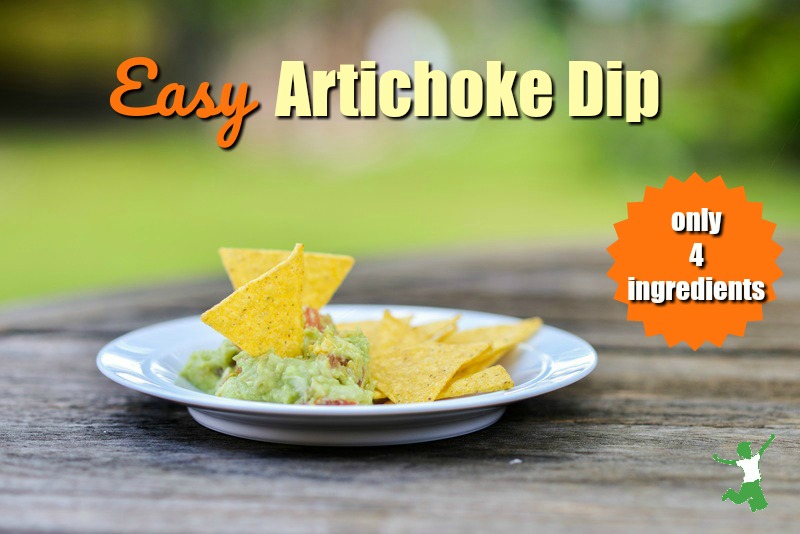 homemade artichoke dip on a white plate with tortilla chips