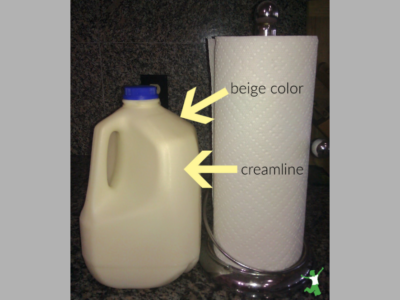 beige color and large creamline of milk from cows eating spring grass
