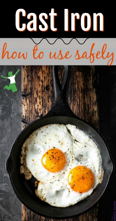 cast iron skillet with two fried eggs on a wooden board