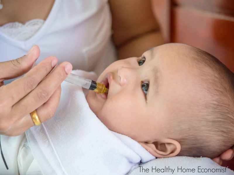 baby getting cod liver oil with an eyedropper