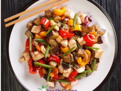 teriyaki chicken and roast vegetables on a white plate with chop sticks