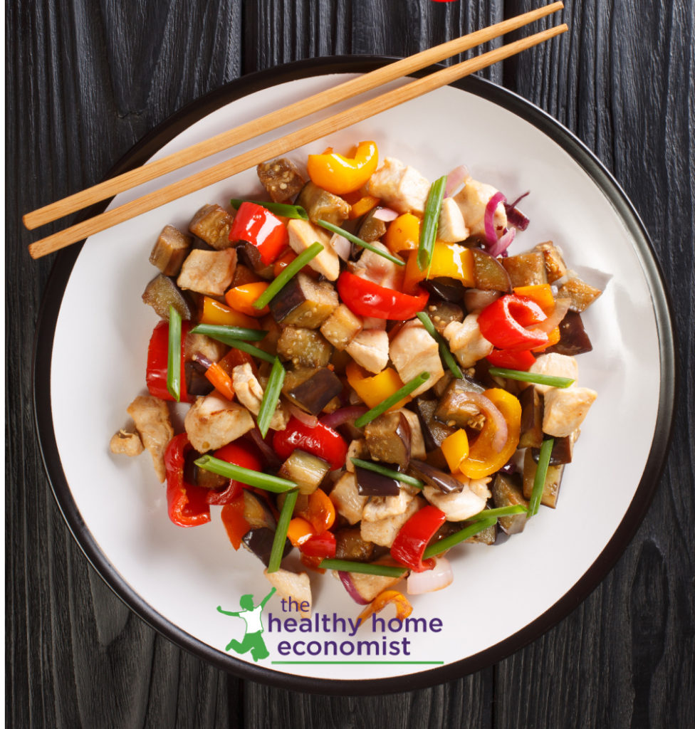 teriyaki chicken and roast vegetables on a white plate with chop sticks