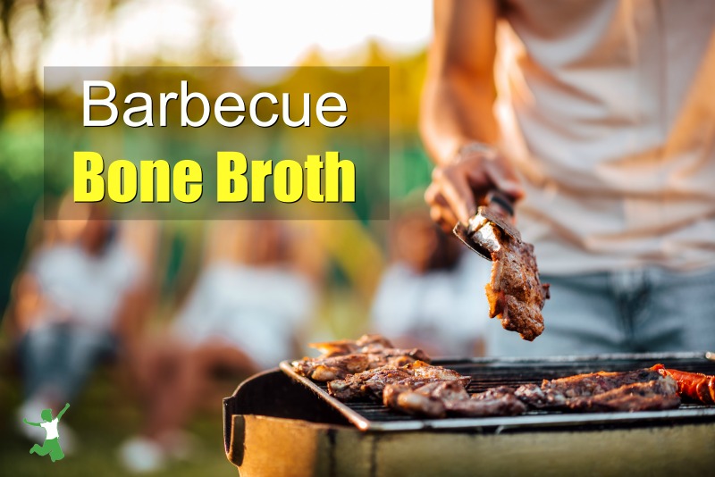 bone-in steaks and chicken on grill with man using tongs