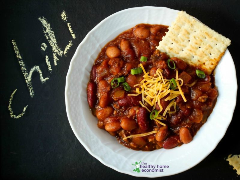 homemade buffalo chili in a white bowl with crackers