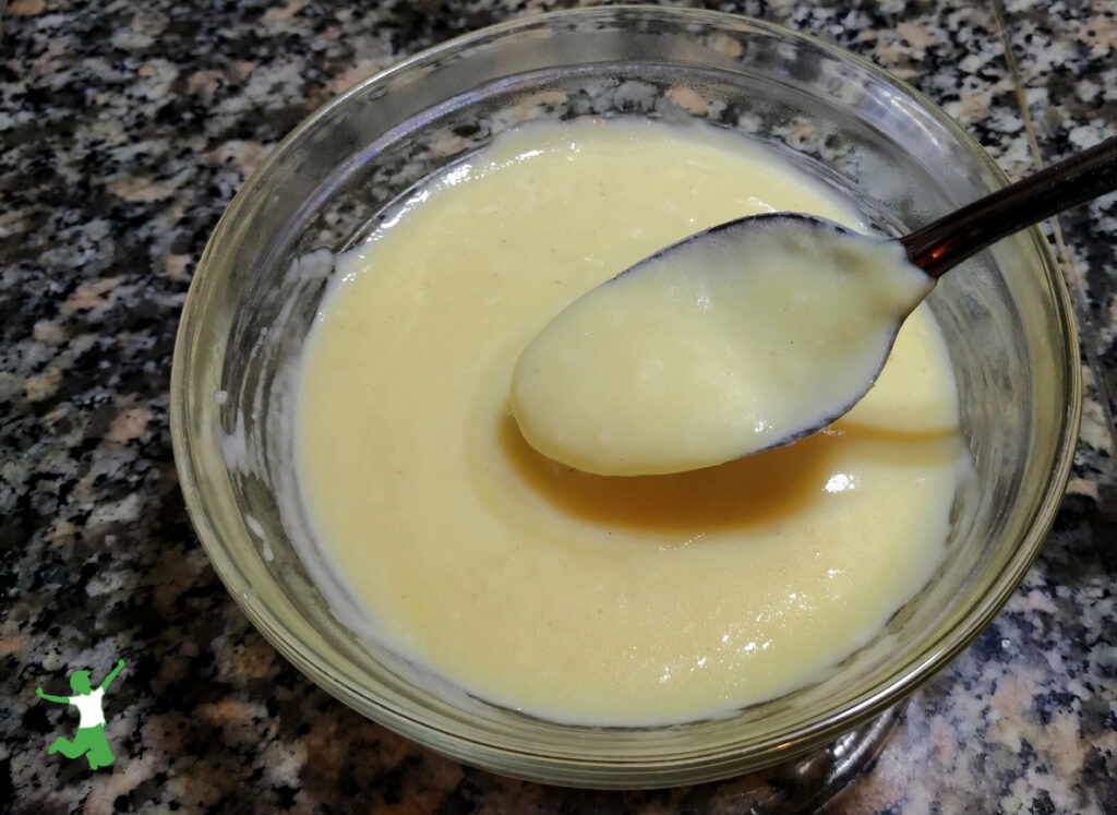 homemade vanilla pudding in glass bowl with spoon