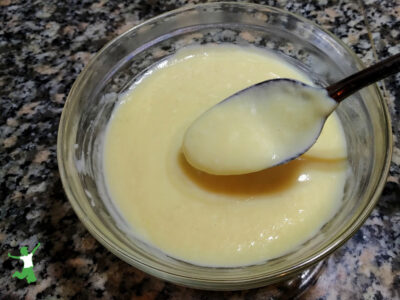 homemade vanilla pudding in glass bowl with spoon
