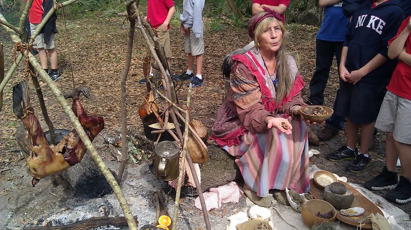 seminole tribe members preparing a meal over a fire