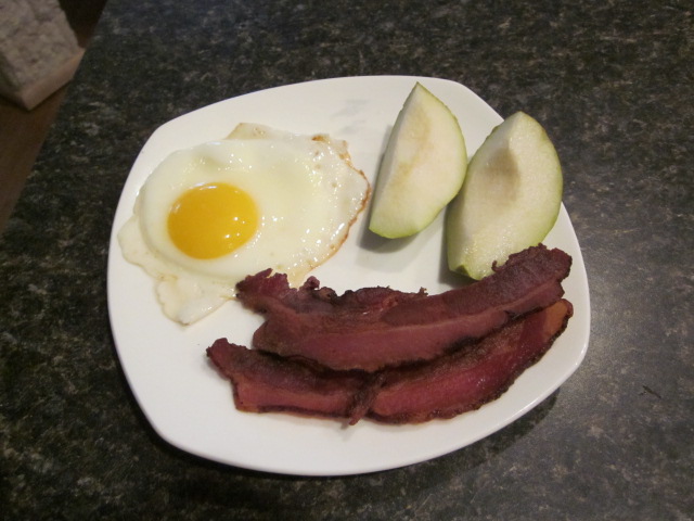 bacon, eggs and pears on a white plate