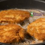 breaded beef heart frying in a pan