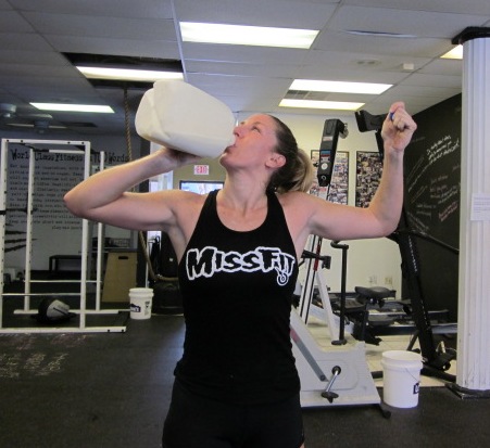 woman chugging raw milk after a morning workout