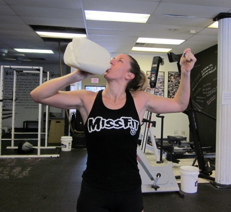 woman chugging raw milk after a morning workout