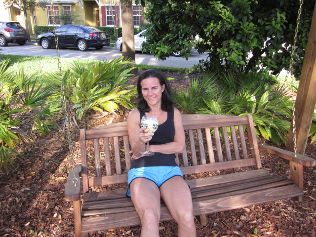 woman sitting on a bench holding a wine glass of raw milk