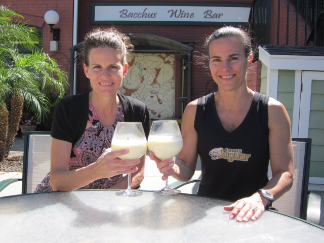 Two women celebrating with a glass of raw milk