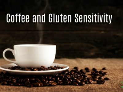 white coffee cup on a table with coffee beans on a dish