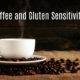 white coffee cup on a table with coffee beans on a dish