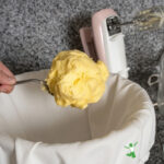 fresh raw butter on a large serving spoon