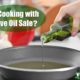 Woman pouring olive oil into a pan on the stove