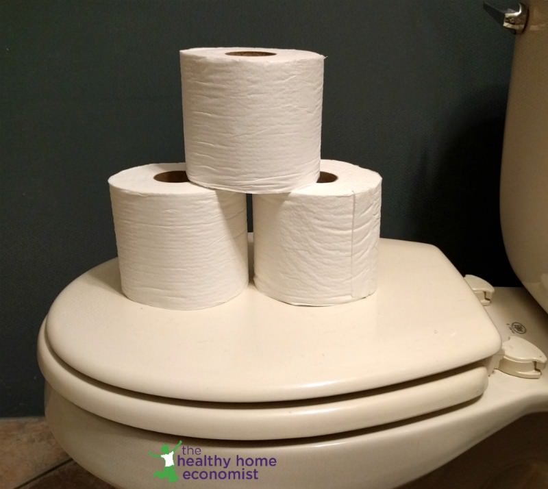 recycled toilet paper stacked on a toilet seat