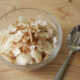 low carb coconut snack chips in glass bowl with spoon