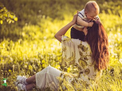 woman who did best exercise for natural birth holding her healthy baby