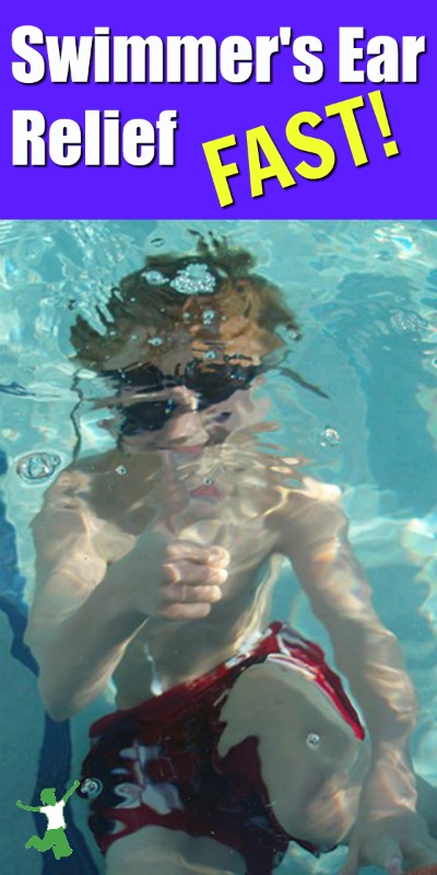 child swimming underwater giving the thumbs up sign