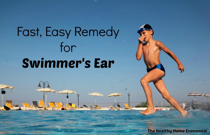 boy holding his nose jumping into a swimming pool