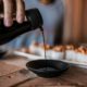 healthy soy sauce drizzling into a ceramic bowl