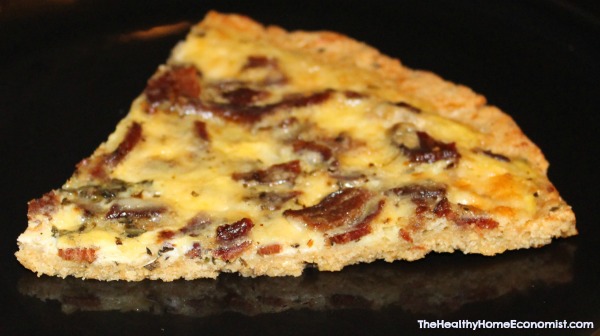 slice of bacon and egg breakfast pizza on a black platter