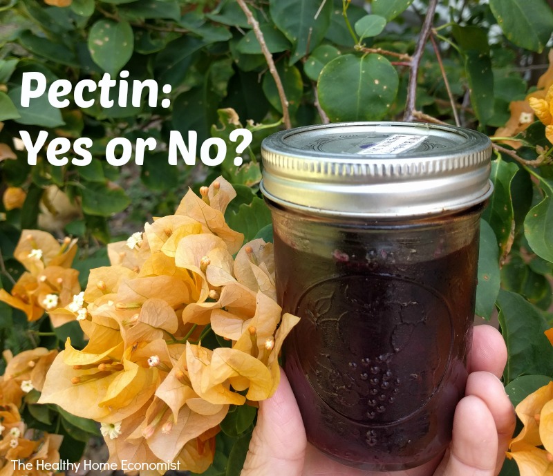 jar of homemade jam thickened with pectin with yellow flowers in the background