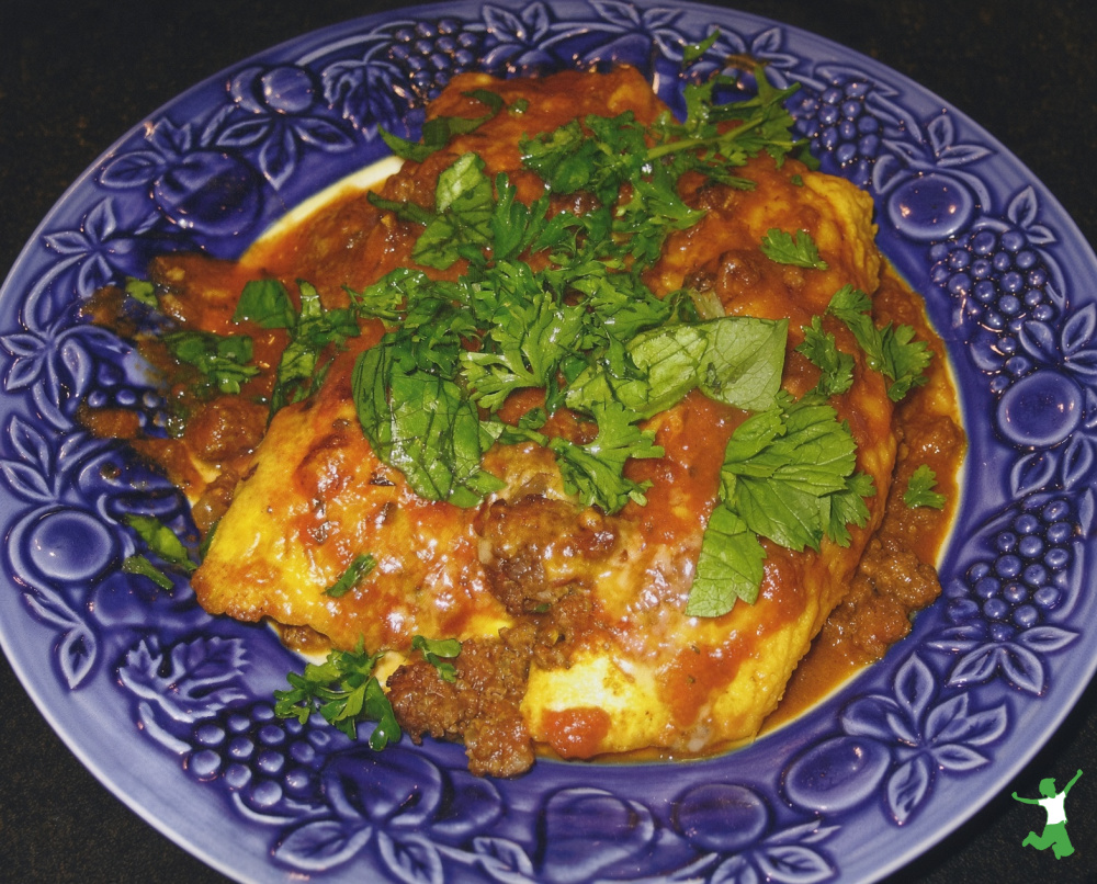 grain-free enchilada on decorative blue plate