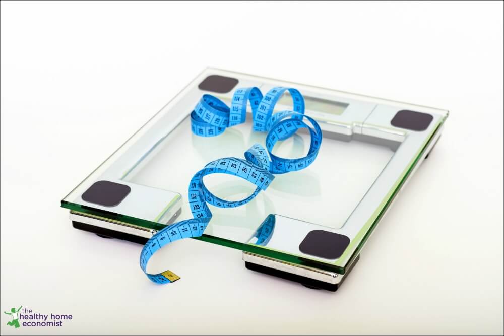 scale with a tape measure to assess progress from weight loss shakes