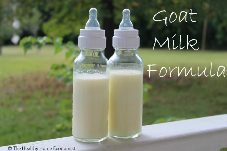 goats milk formula in glass bottles on a porch railing