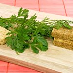 homemade bouillon cubes with lovage leaves on cutting board