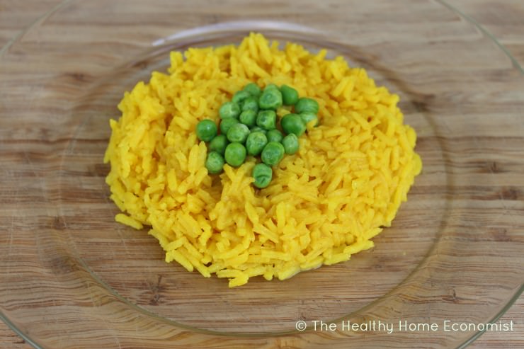 yellow rice arroz amarillo on a glass plate with peas