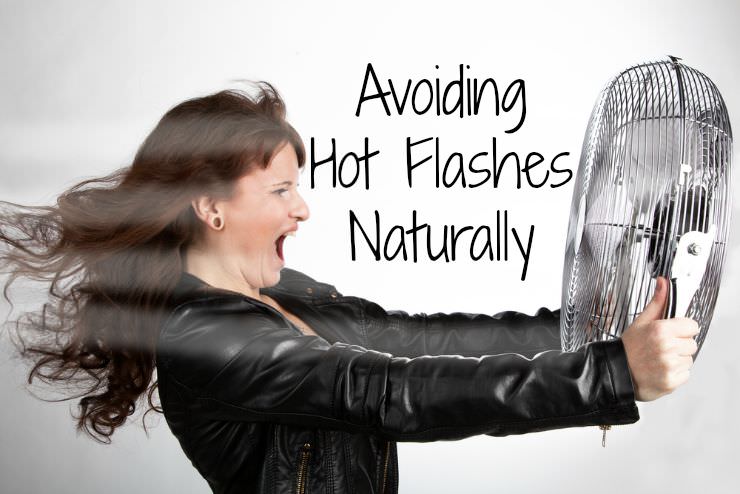 woman holding a large fan to avoid hot flashes naturally