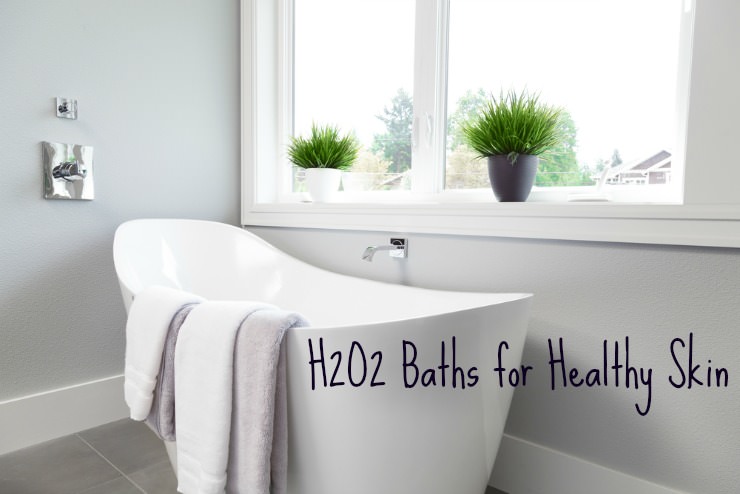 white bathtub with towels draped over the side for taking a hydrogen peroxide bath