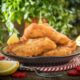 healthy fish fingers on platter with lemon