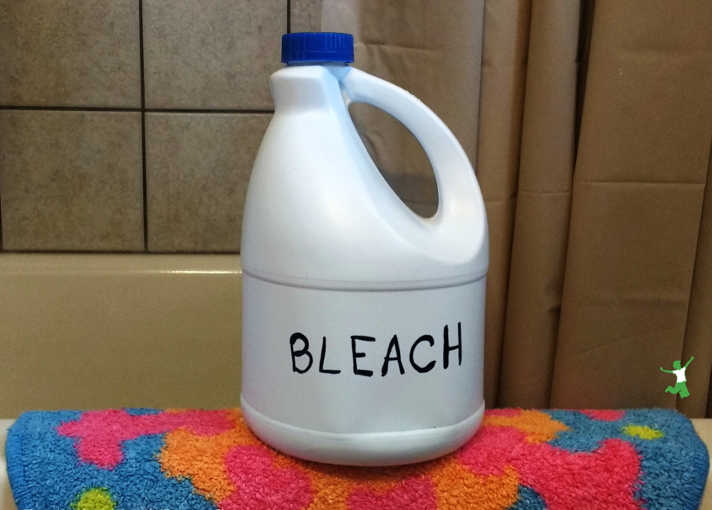 bottle of bleach on side of bath tub